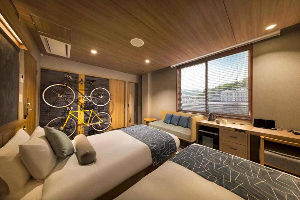 Postel nebo postele na pokoji v ubytování HOTEL BEACON ONOMICHI