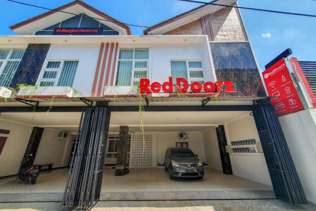 a car parked in the garage of a building at RedDoorz Syariah near Solo Paragon Mall 2 in Bonorejo