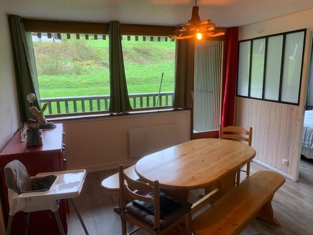 a dining room with a wooden table and a window at Appartement Mont-Dore, 2 pièces, 5 personnes - FR-1-415-114 in Le Mont-Dore