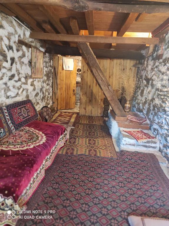 an attic room with a bed and wooden walls at Lübbey butik otel in Dolaylar