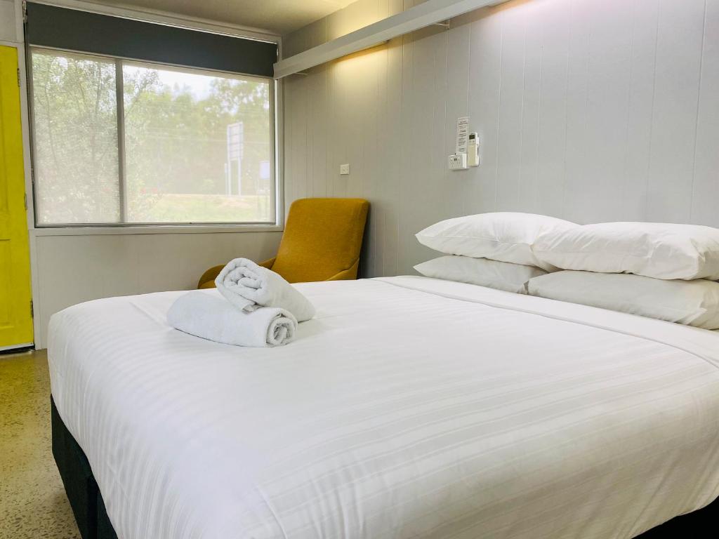 a bedroom with two beds with a towel on top of it at 24HourCheck-In- Bridgewater Motel-Victoria-Australia in Bridgewater-on-Loddon