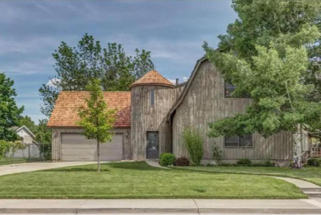 a large wooden house with a garage at Unique Home Perfect for Large Gatherings. Pets welcome! in Orem