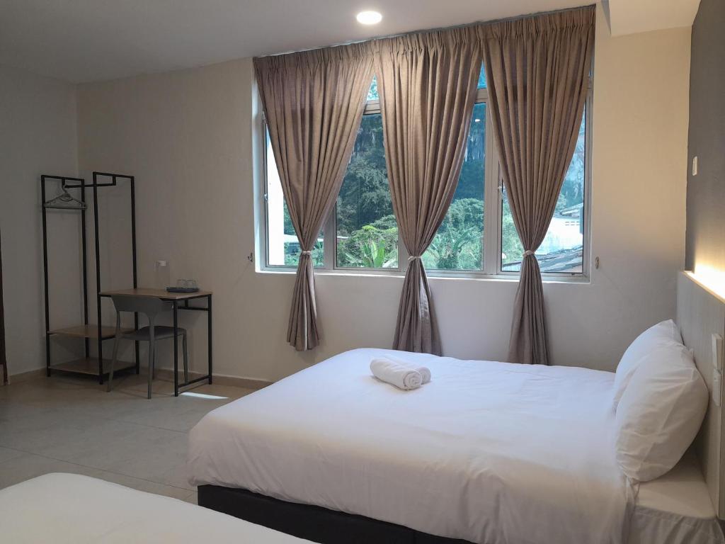 a bedroom with two beds and a window at The great in Ipoh