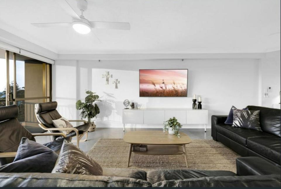 a living room with a couch and a table at Gemini Court - Hosted by Burleigh Letting in Gold Coast