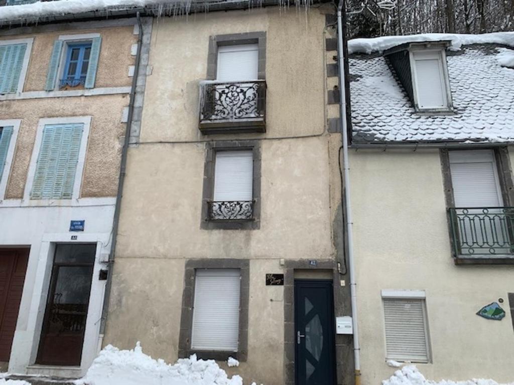 a building with snow on the ground in front of it at Studio Mont-Dore, 1 pièce, 2 personnes - FR-1-415-108 in Le Mont-Dore