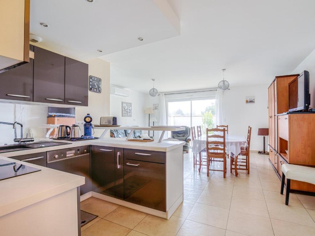 a kitchen with a table and a dining room at Maison T5 à Biscarrosse avec 4 chambres, clim, WIFI, terrasse, proche activités et plages - FR-1-521-156 in Biscarrosse