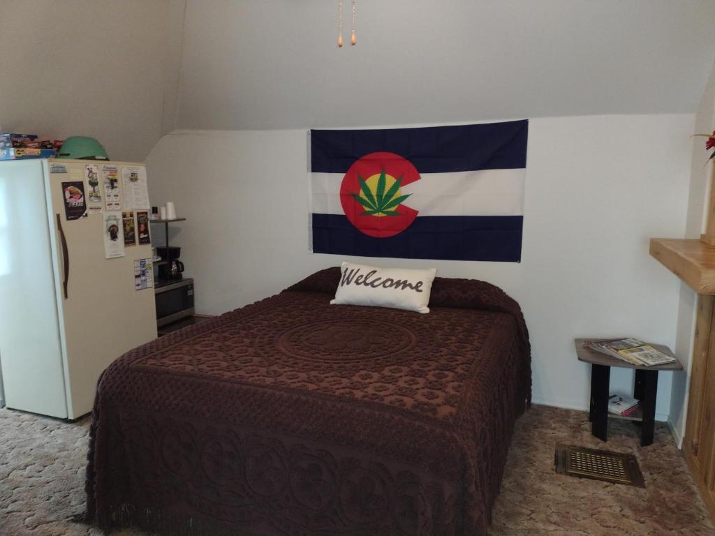 a bedroom with a bed and a flag on the wall at Quiet upstairs studio close to town 420 friendly in Trinidad