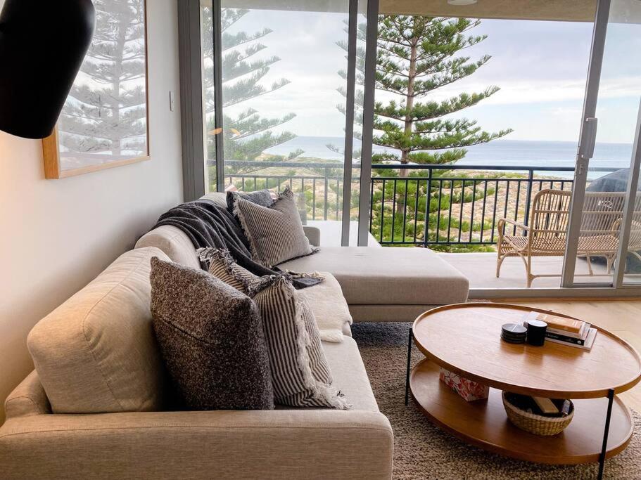 a living room with a couch and a table at HoneyB - 2 bed Apt on the beach in Perth