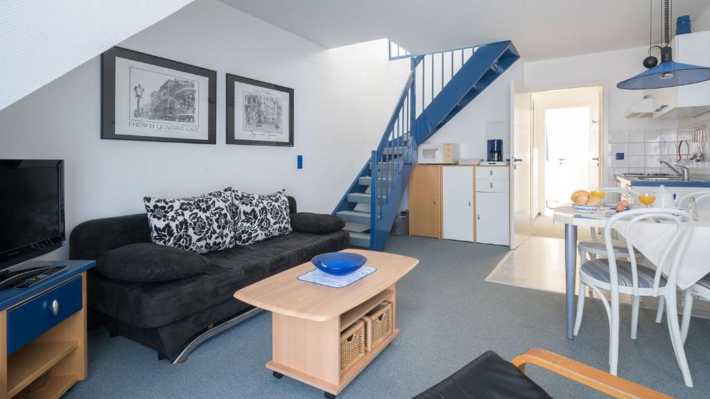 a living room with a couch and a table at null Haus Frisia, Whg 407 in Sankt Peter-Ording