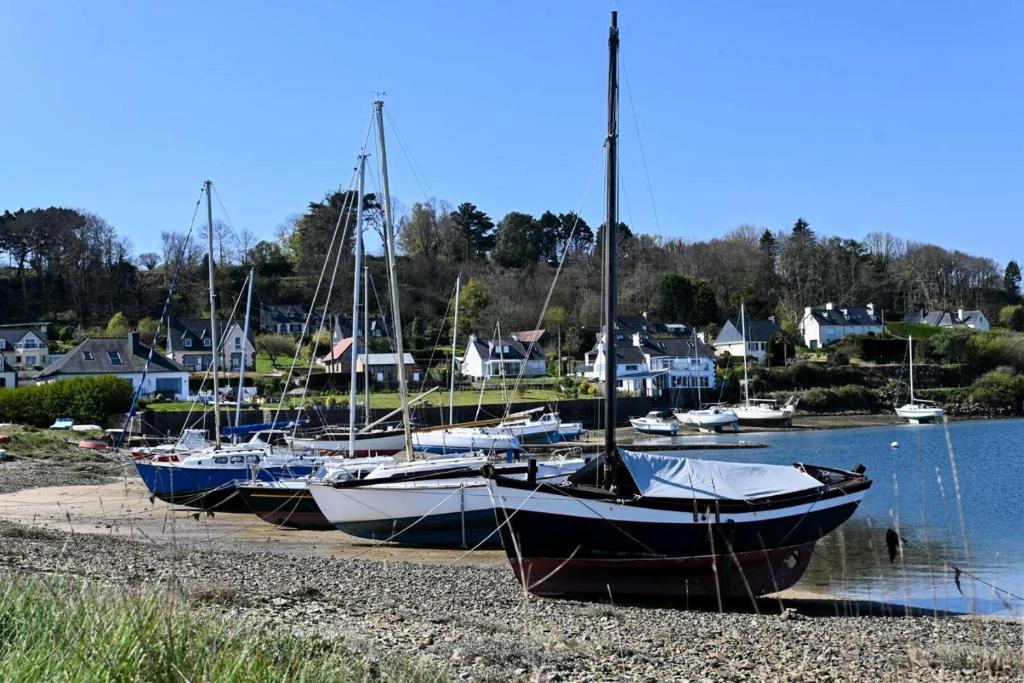 a group of boats are docked on the shore at Résidence Le Lenn-louannec - Maisons &amp; Villas pour 6 Personnes 784 in Lannion