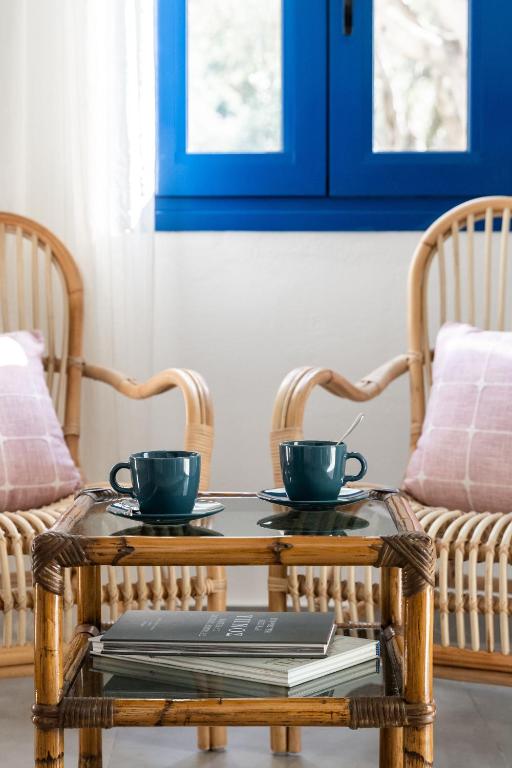 two cups on a coffee table with two wicker chairs at Alasthas in Gavrio