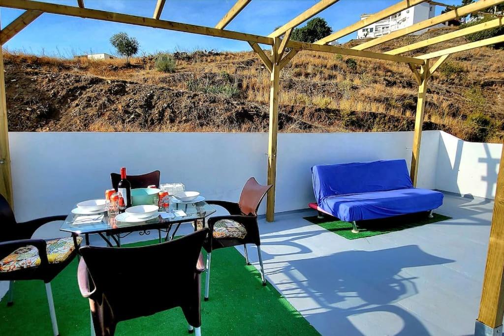 a patio with a table and chairs and a couch at Costa de Granada Calle peatonal in Salobreña