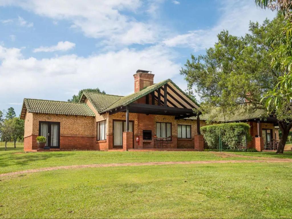 a brick house with a grassy yard at 26 on Greenway in White River