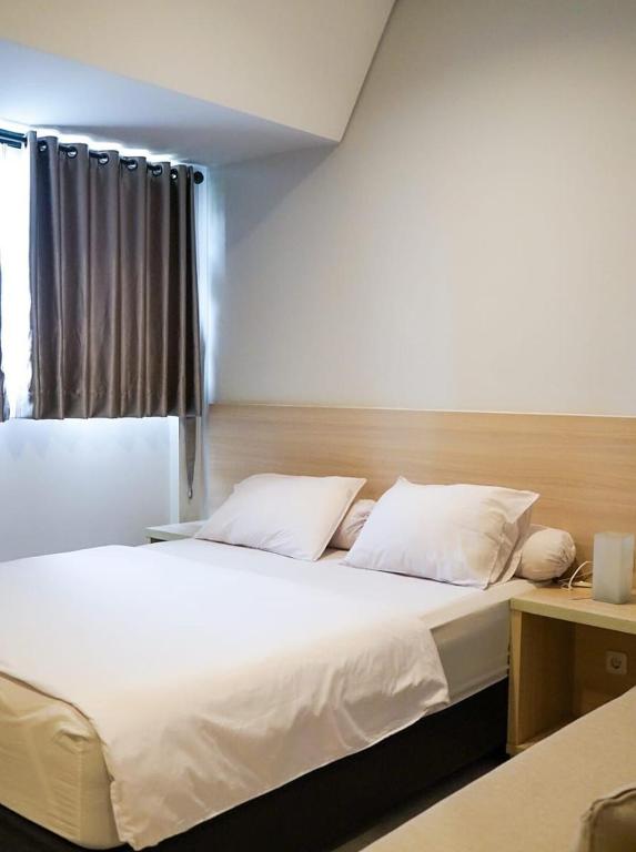 Postel nebo postele na pokoji v ubytování Mendjangan Residence