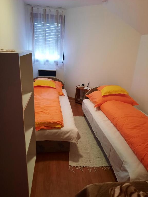 A bed or beds in a room at Zsuzsanna vendégház