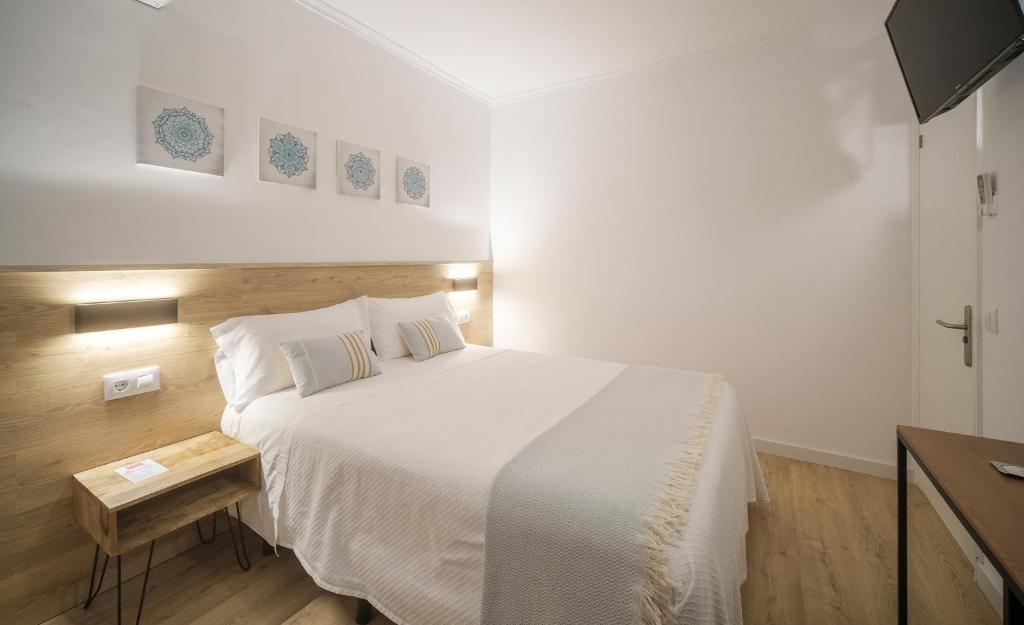 Posteľ alebo postele v izbe v ubytovaní Hostal Menurka