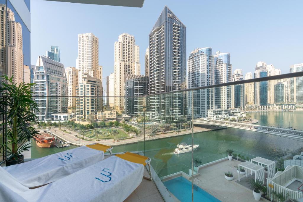 a view of a city from the balcony of a building at Vacay Lettings - Waterfront Luxury home with full Marina view in Dubai