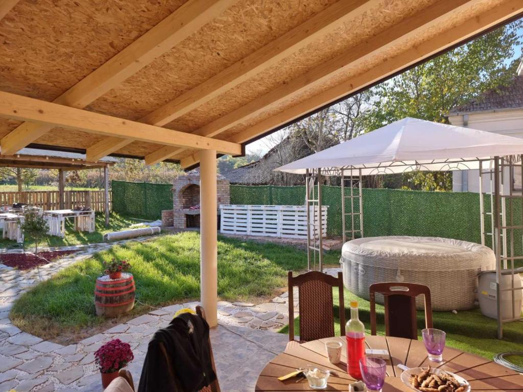 a patio with tables and umbrellas in a backyard at Hacijenda Milosavljević in Vrnjačka Banja