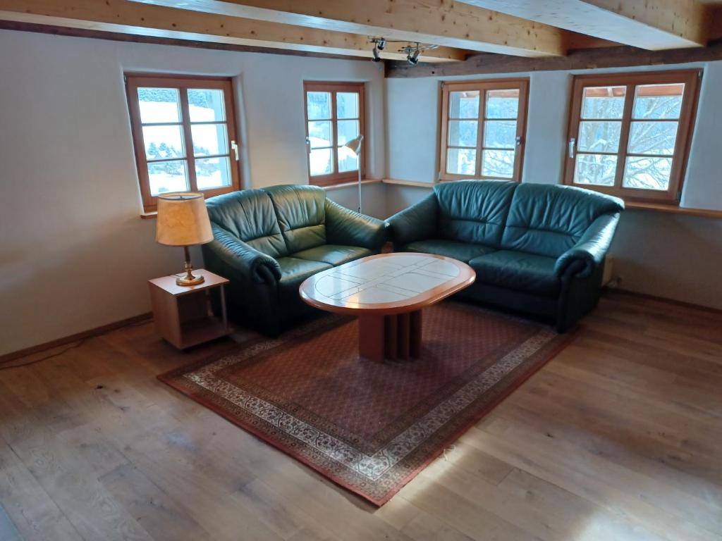 a living room with two couches and a table at Schwarzwaldstube in Titisee-Neustadt