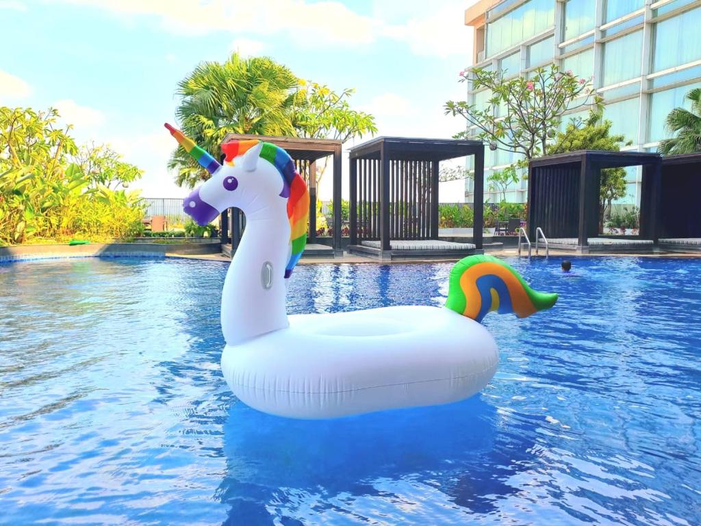a unicorn float in the water in a pool at The Luxton Cirebon Hotel and Convention in Cirebon