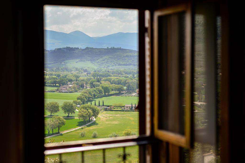 a view of a field from a window at City Center Apartments - Happy Rentals in Spello