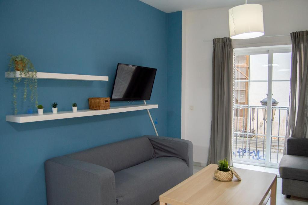 Televízia a/alebo spoločenská miestnosť v ubytovaní Novam Apartament