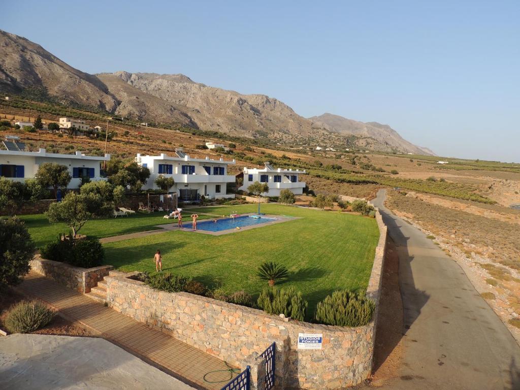 arial view of a villa with a yard and houses at Studios Fokies in Hora Sfakion