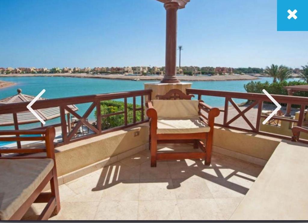 a balcony with chairs and a view of the water at 4 Bed El Gouna Villa in Hurghada