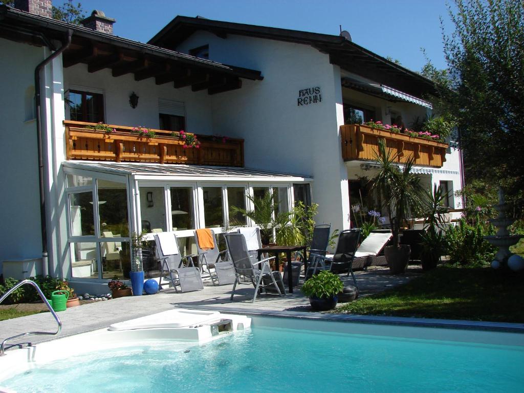 a house with a swimming pool in front of a house at Appartement im Souterrain mit Terrasse in Bischofswiesen