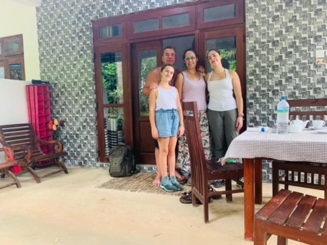 a group of people standing in front of a house at Quiet Rest Inn in Ella