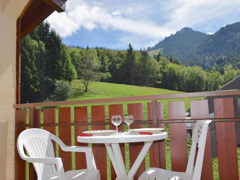 a table with two glasses of wine on a balcony at Appartement Bernex, 2 pièces, 6 personnes - FR-1-498-31 in Bernex