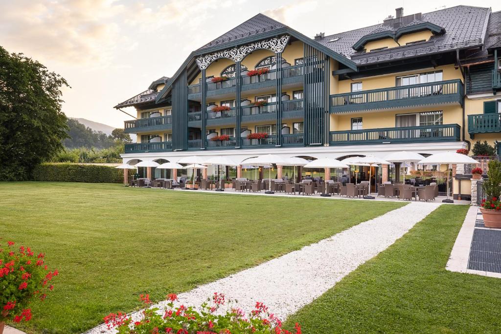 a hotel with a lawn in front of it at Hotel Friesacher in Anif