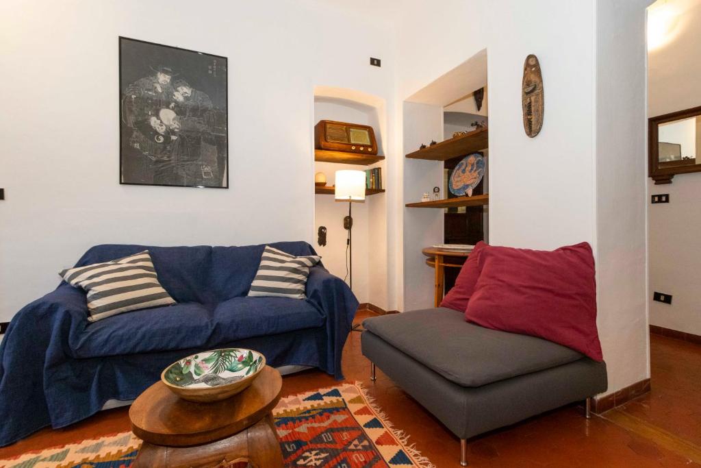 a living room with a couch and a chair at Mercato Centrale Roomy Apartment in Turin