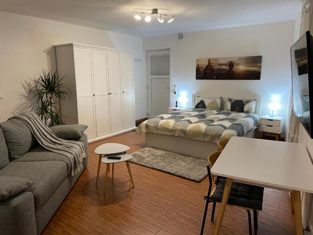 a living room with a bed and a couch at Apartment Fulda Aue in Fulda