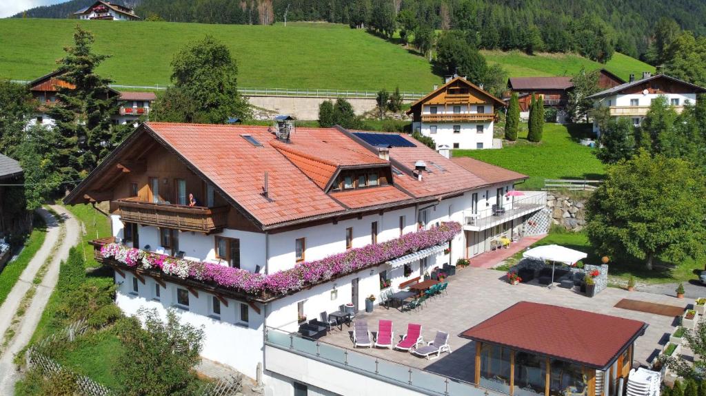 an aerial view of a house with a roof at Pension Wirt am Bach in Terento
