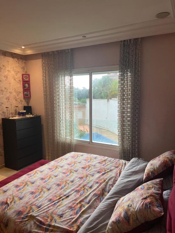 a bedroom with a large bed and a window at Villa “el Jefe Del Mar” in Casablanca