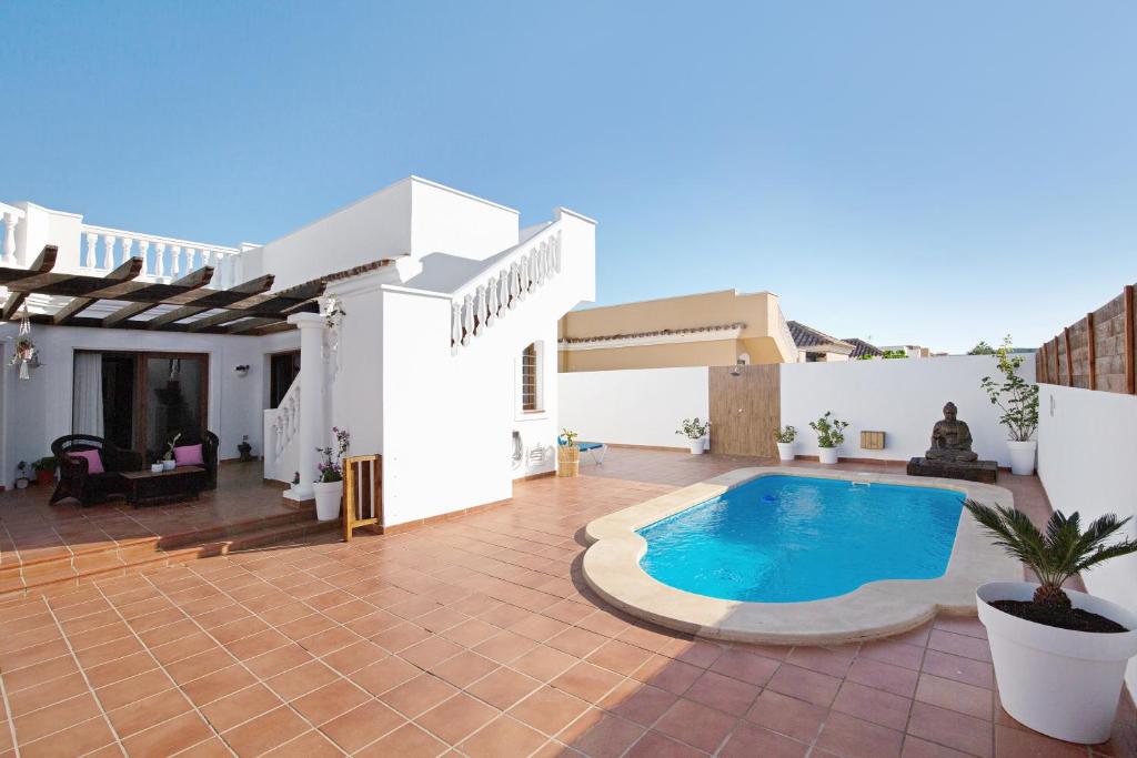 a villa with a swimming pool on a patio at Villa Baobab in Corralejo