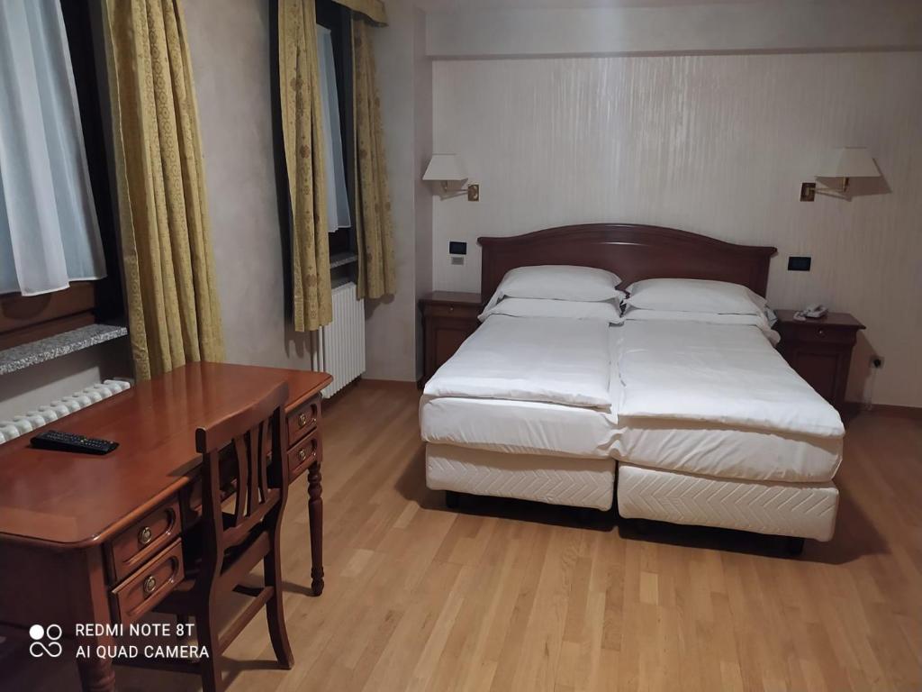 Postel nebo postele na pokoji v ubytování Hotel Breuil