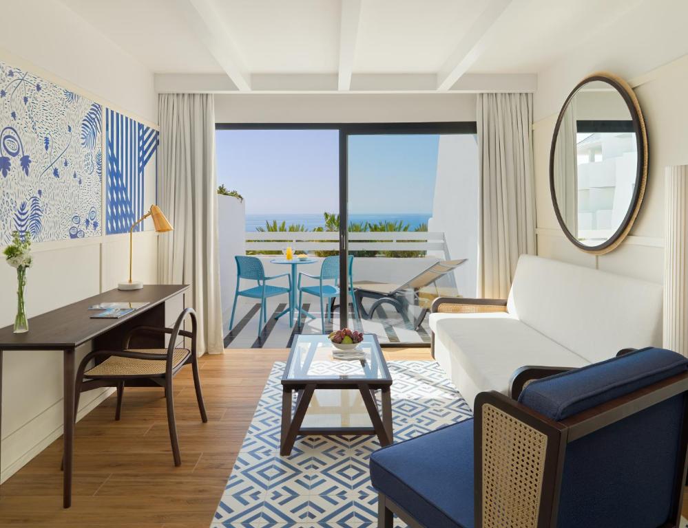 a living room with a couch and a table at H10 Estepona Palace in Estepona