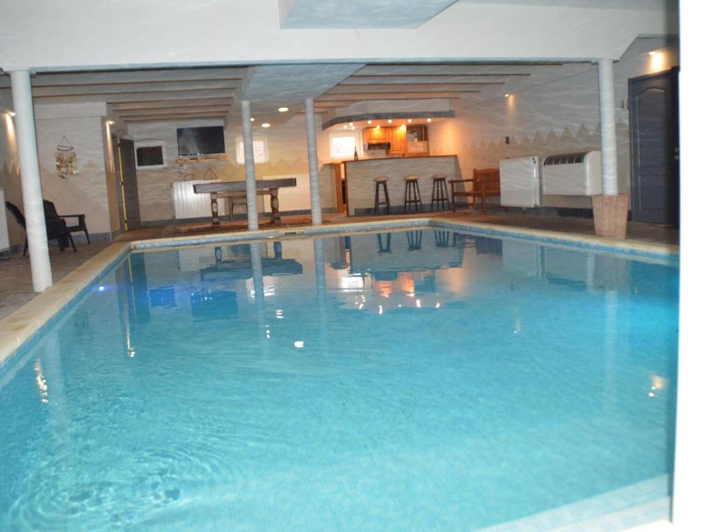 a large blue swimming pool in a hotel at Vacation home in Verviers with private indoor pool in Verviers