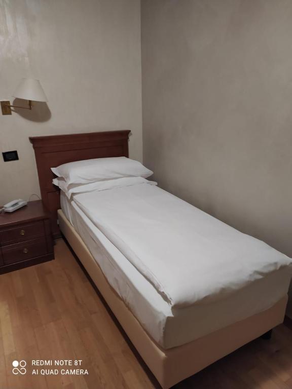 Postel nebo postele na pokoji v ubytování Hotel Breuil