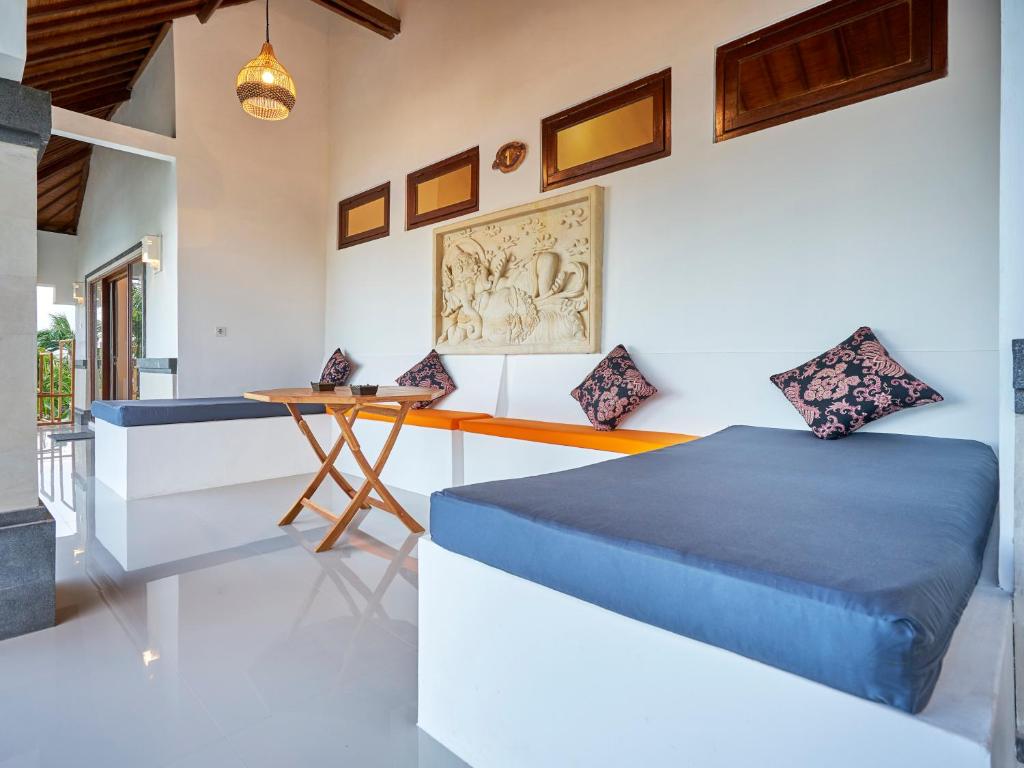 a bedroom with a bed and a desk at Anda Amed Villas & Spa in Amed