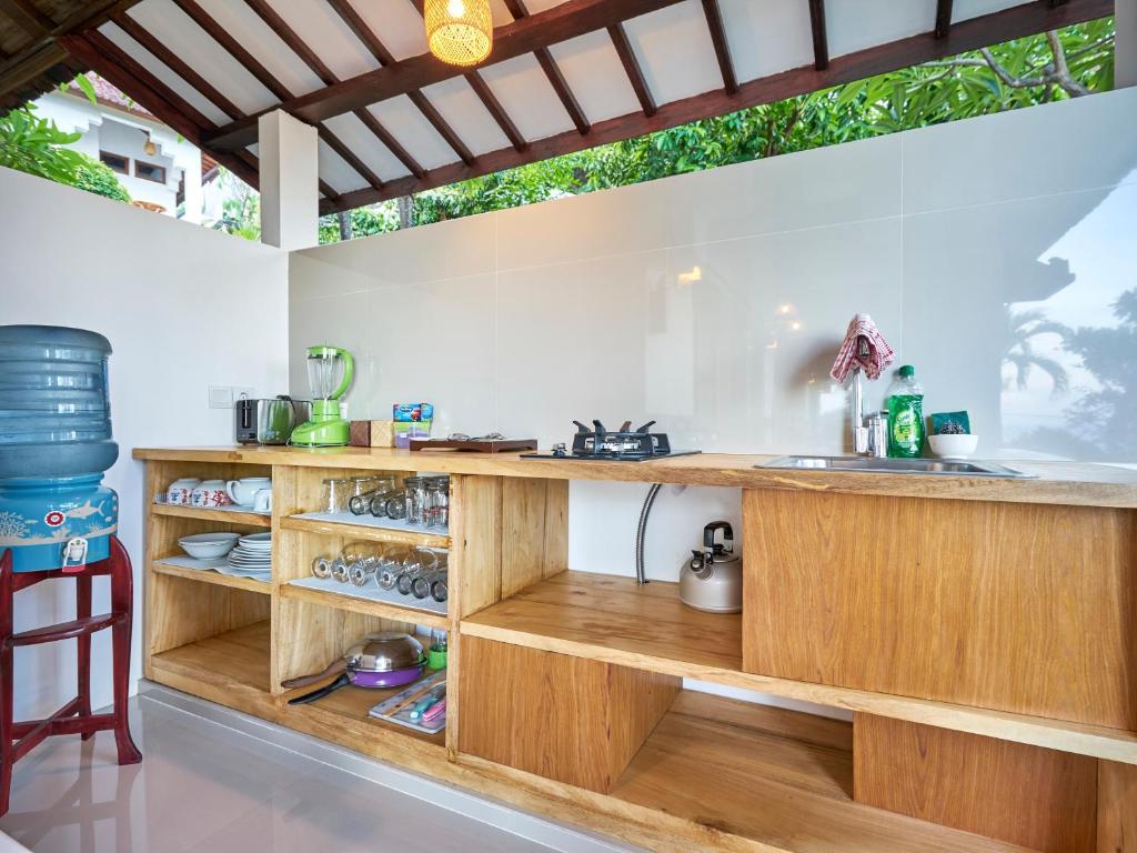 a kitchen with a wooden counter and a sink at Anda Amed Villas & Spa in Amed