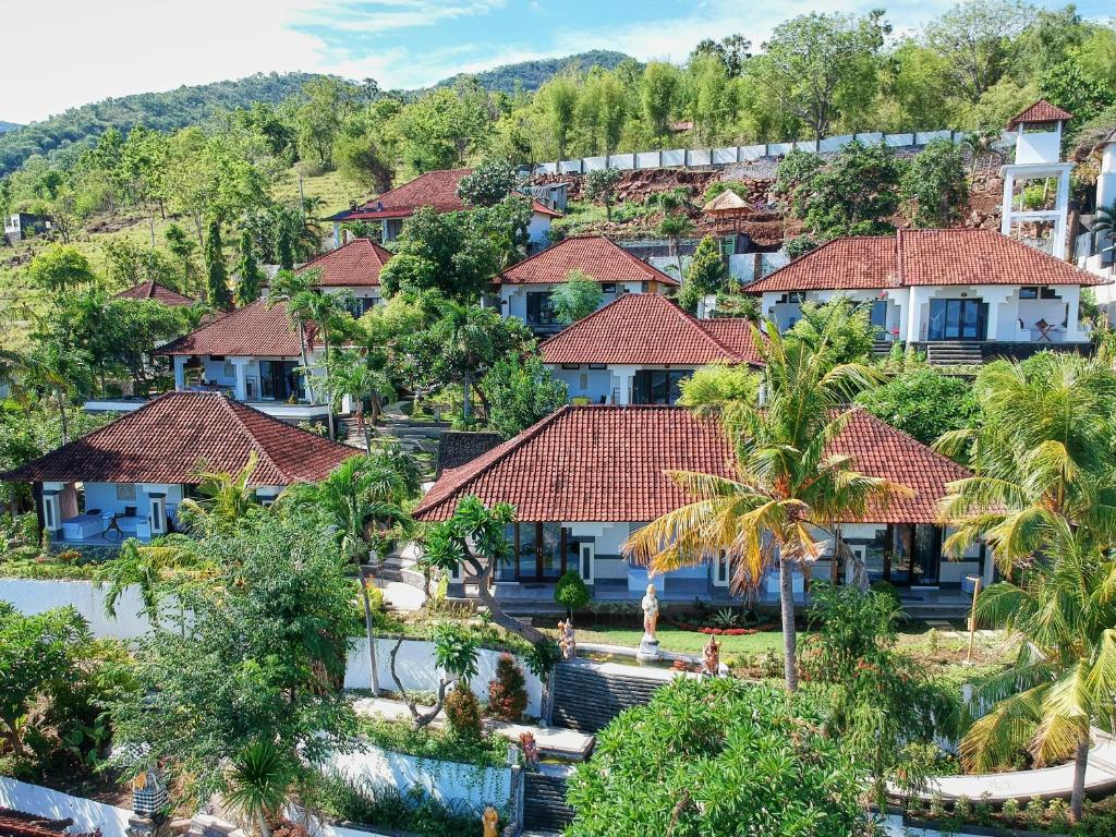 an aerial view of a resort with palm trees at Anda Amed Villas & Spa in Amed