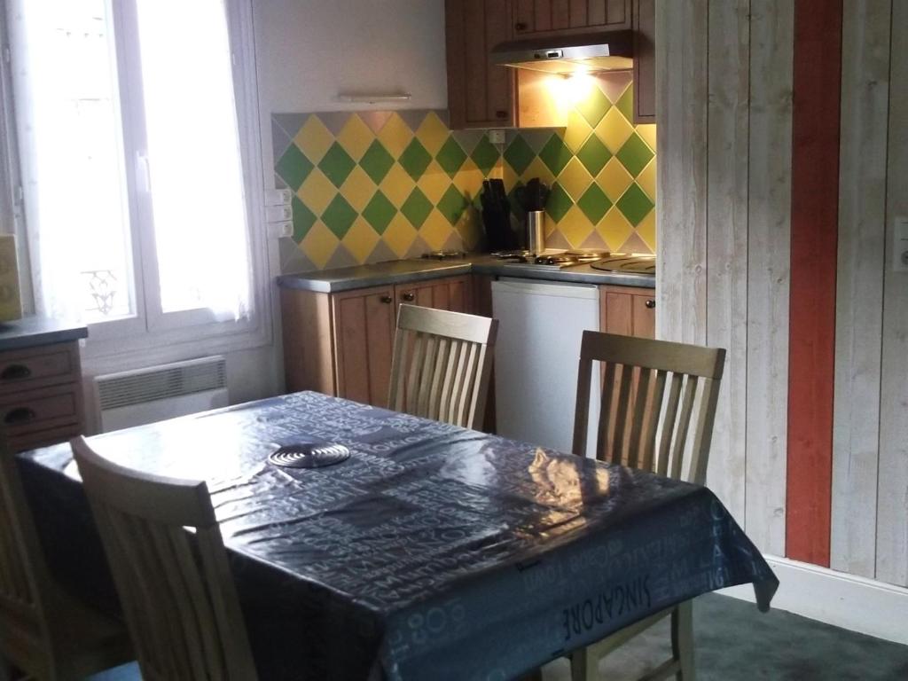 een keuken met een tafel en stoelen en een keuken met een tafel en een keuken bij Appartement Mont-Dore, 3 pièces, 4 personnes - FR-1-415-61 in Le Mont-Dore