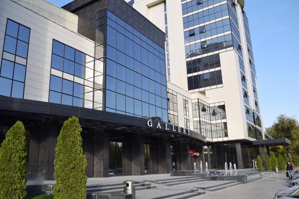 a building with a sign on the front of it at Stylish apartment in the city center in Bishkek