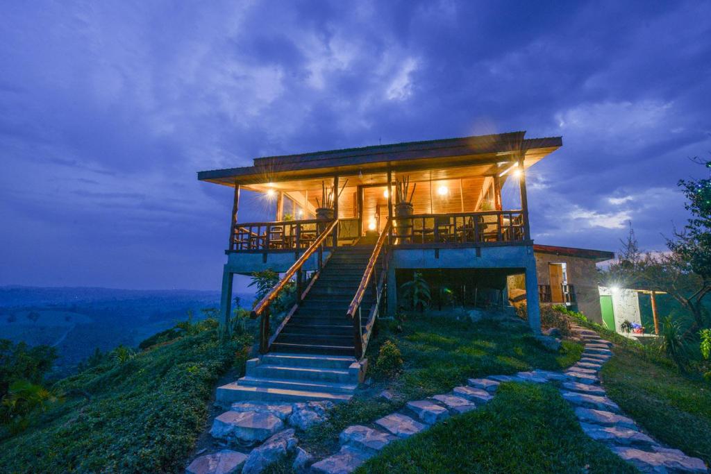 a house on top of a hill with stairs at The Coffee Lodge at Clarke Farm in Fort Portal
