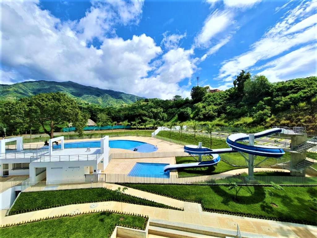 una casa con una piscina con montañas en el fondo en Acogedor, Gran Vista a las Montañas y a la Ciudad!, en Santa Fe de Antioquia