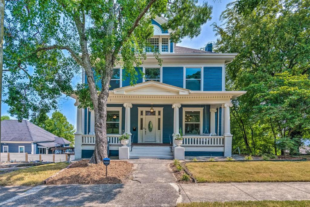 a blue house with a tree in front of it at The Darcy in Hot Springs