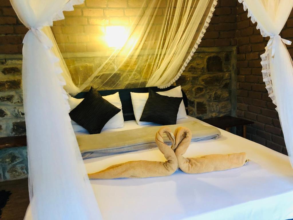 Postel nebo postele na pokoji v ubytování Wild Resort Ella